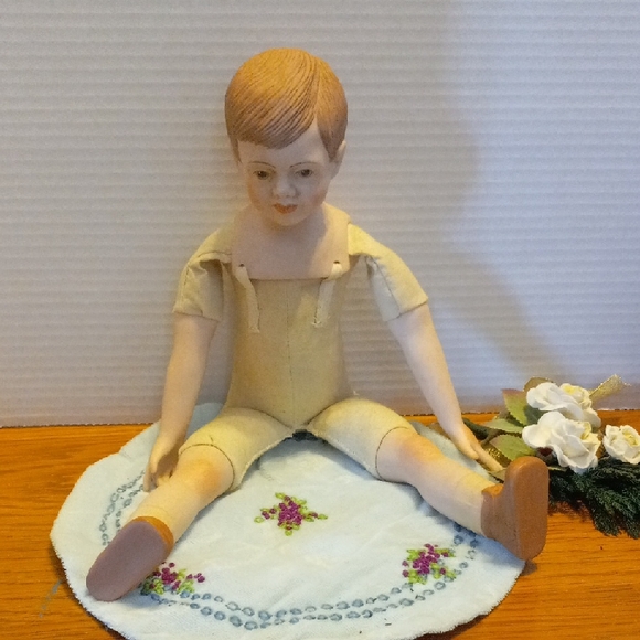 Vintage Porcelain Doll with Embroidered Mat